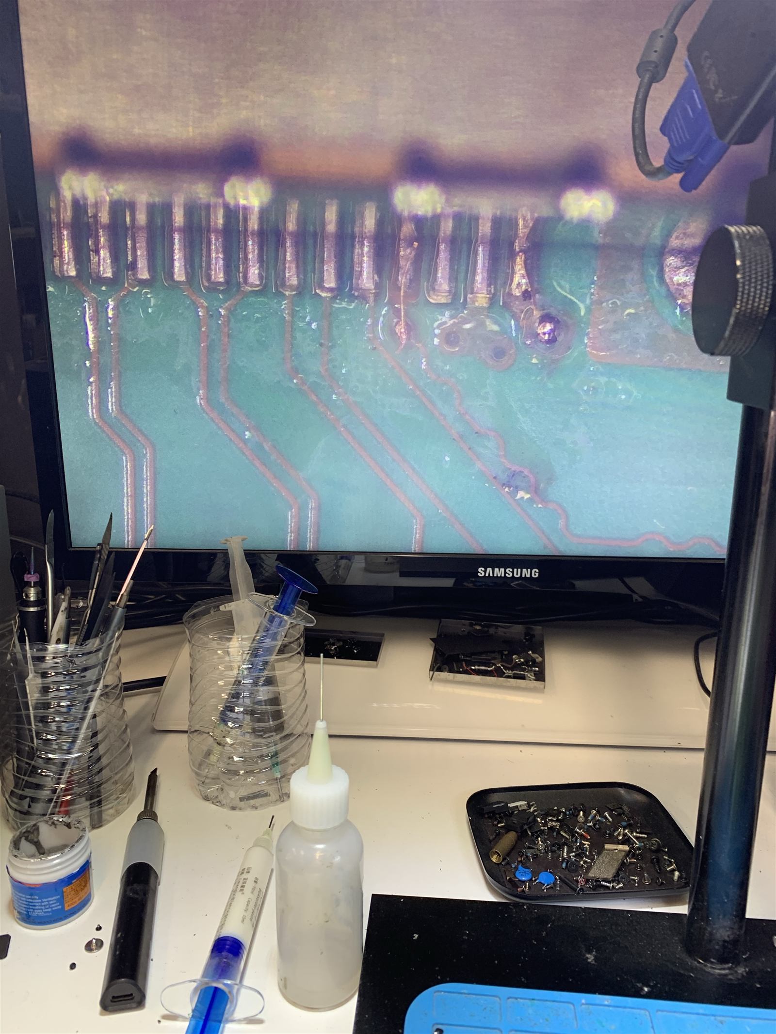 Microscope view of Xbox HDMI port pads and traces with several pads torn off the board