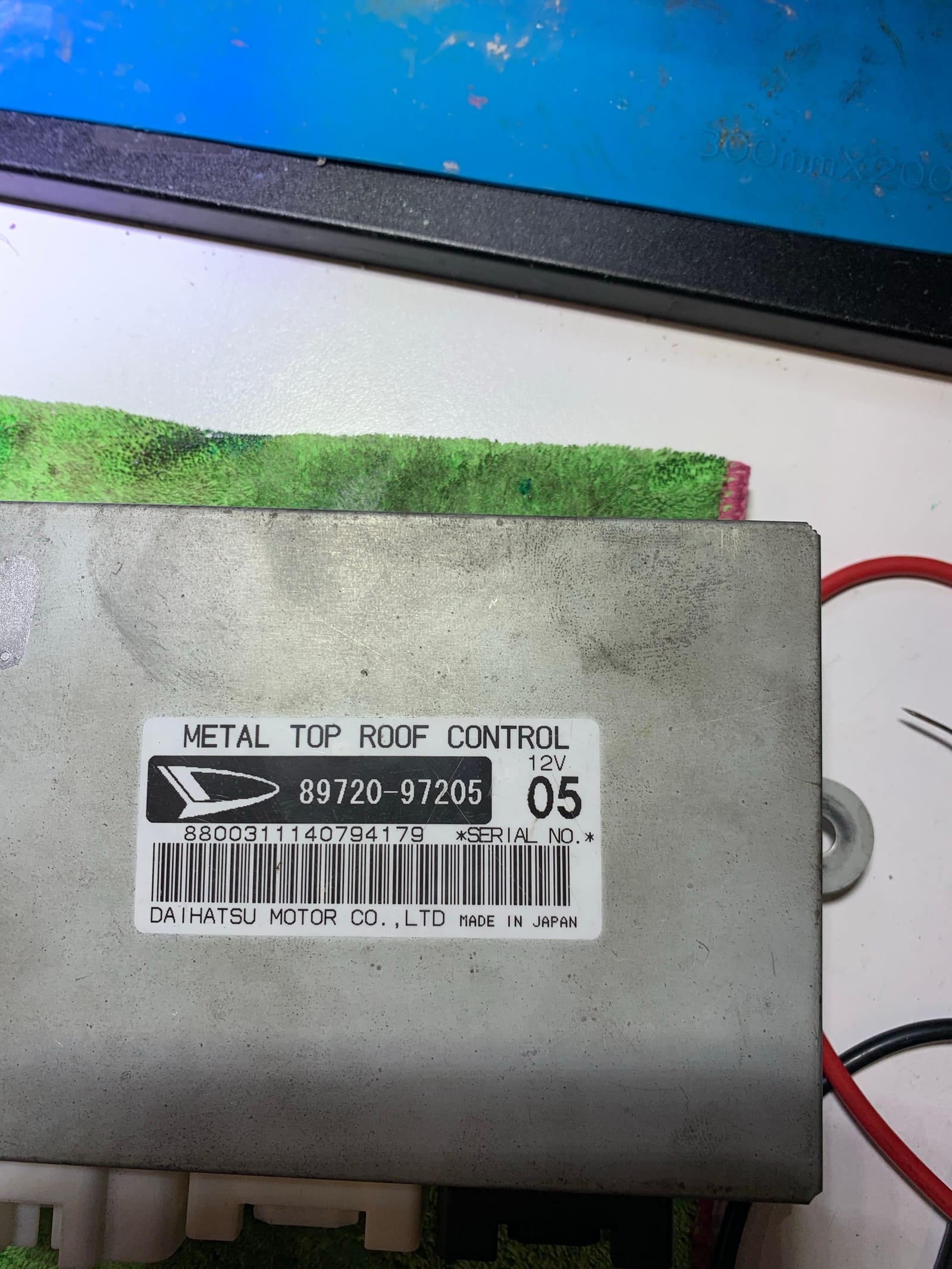 Daihatsu Metal Top Roof Control ECU module on the bench, showing its identification label before diagnosis
