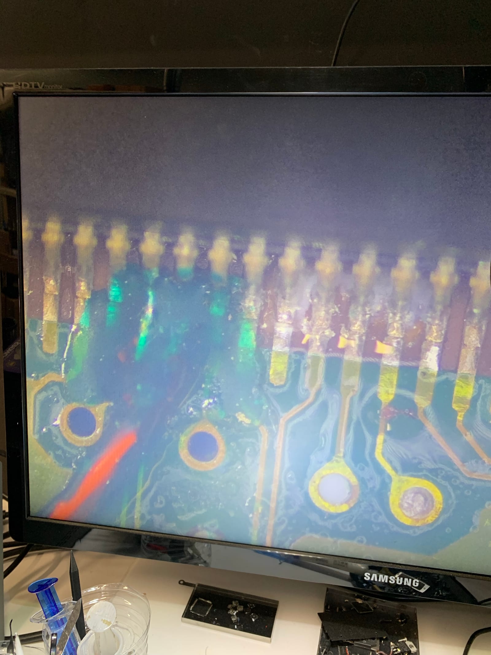 Microscope view of the ECU's MCU legs and surrounding PCB traces during inspection