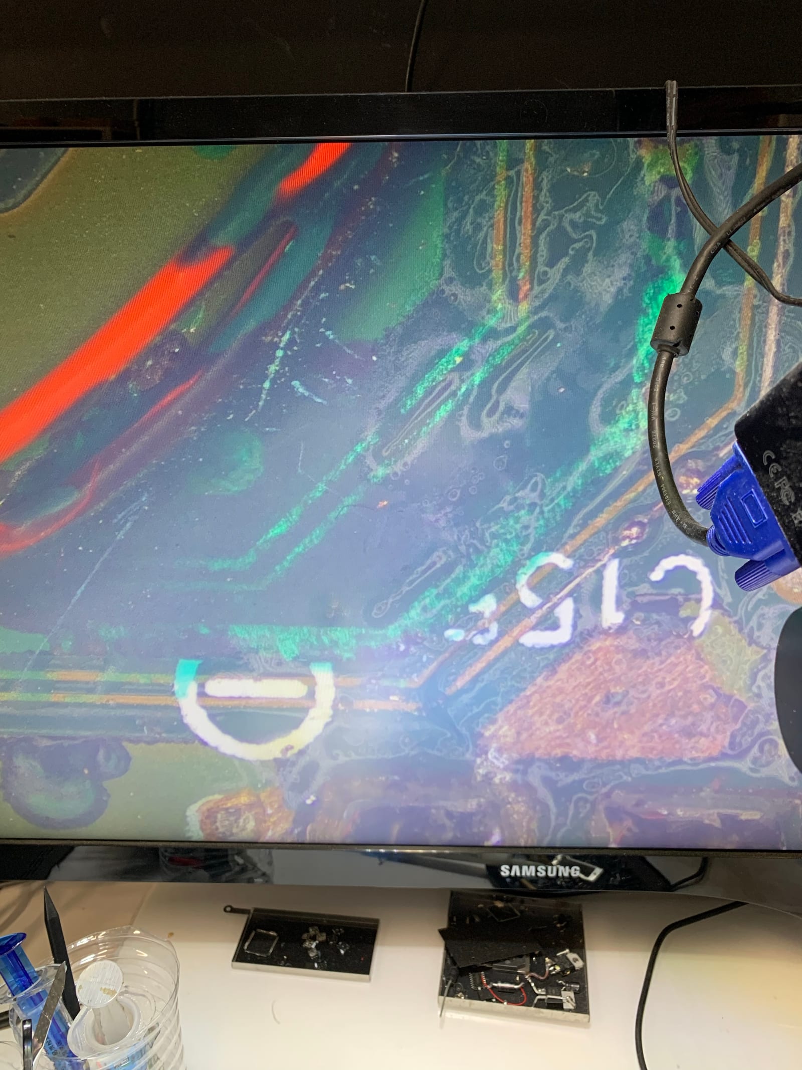 Second microscope view of corroded PCB traces near the ECU's MCU, showing further electrolyte damage